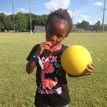 Girl at NORDC Family Fest holding a dodgeball